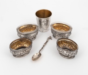 120 · Continental silver beaker, spoon and four salt cellars (two with glass liners), 19th/20th century, (6 items), ​​​​​​​the beaker 6cm high, 157 grams silver weight (not including liners).
