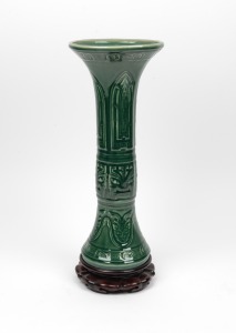 A Chinese green porcelain Gu vase with carved wooden stand, 20th century, seal mark to base, 44.5cm high overall