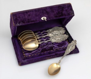 A set of six American silver parfait spoons with attractive Art Nouveau handles and gilt wash finish, housed in purple velvet fitted box, 19th/20th century, the box 18cm wide, 146 grams total