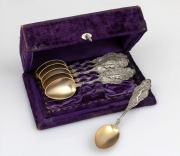 A set of six American silver parfait spoons with attractive Art Nouveau&nbsp;handles and gilt wash finish, housed in purple velvet fitted box, 19th/20th century, the box 18cm wide, 146 grams total