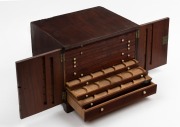 An antique mahogany two door coin collector's cabinet with lozenge shaped ivory escutcheons, interior handsomely fitted with a selection of drawer slides with coin apertures, 19th century, 22.5cm high, 29cm wide, 22cm deep