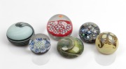Six assorted glass paperweights including millefiore, Murano&nbsp;glass, and Caithness, 20th century, the largest 6.5cm high, 8cm diameter.