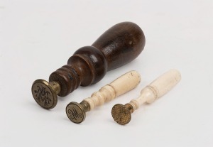 Three antique seals, turned ivory, whalebone and wood, 19th century, ​​​​​​​the largest 9cm high.