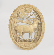 An antique carved deer antler brooch, impressively adorned with stag in landscape, 19th century, 5cm high