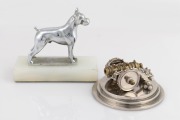 A nickel plated cast bronze dog statue on a white onyx plinth, together with an engineer made miniature cannon, 20th century, (2 items),the dog 11cm high.