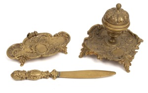 An antique French bronze inkwell with porcelain liner, together with a similar letter opener and pen tray, 19th century, (3 items), the opener 21cm long.