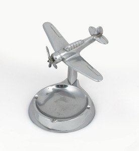 A vintage chrome finished aeroplane desk ornament ashtray, mid 20th century, ​​​​​​​13.5cm high.