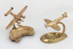 Two vintage brass&nbsp;finished aeroplane desk ornament ashtrays, one with Australian map base, the other a spitfire, mid 20th century, the larger ​​​​​​​13.5cm high.