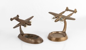 Two vintage bronze finished aeroplane desk ornament ashtrays, mid 20th century, the larger ​​​​​​​13.5cm high.