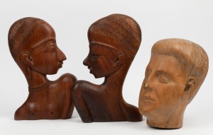 A pair of carved timber tribal style plaques; together with a carved timber head, 20th century, (3 items), the largest 30cm high