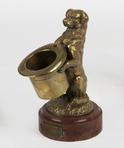 An antique bronze and rouge marble match vesta in the form of a dog holding a top hat, 19th century, 14cm high