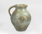 SUSIE COOPER green glazed pottery ale jug with incised ram decoration, signed "Susie Cooper, England", 21.5cm high