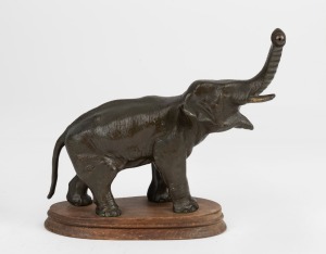 MYSTERY CLOCK cast bronze elephant stand on wooden base, (missing fittings and timepiece), circa 1910, 20cm high