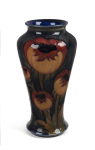 MOORCROFT "Poppy" pattern vase on blue ground, stamped "Moorcroft, Made In England", 26cm high.
