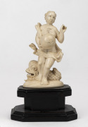 An antique Dieppe ivory fertility statue of a woman and dolphin, mounted on ebonised timber base, 19th century, 12cm high overall