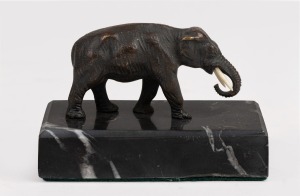 A fine quality antique bronze miniature statue of an elephant with ivory tusk, mounted on black marble base, 19th century, 6cm high, 9cm long overall