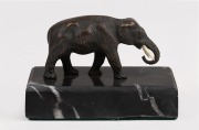 A fine quality antique bronze miniature statue of an elephant with ivory tusk, mounted on black marble base, 19th century, 6cm high, 9cm long overall