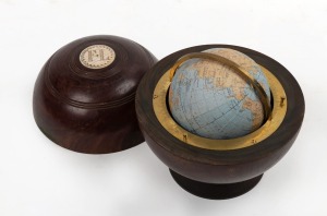A miniature globe attractively housed in a lignum vitae vintage bowling, late 20th century, 12cm high
