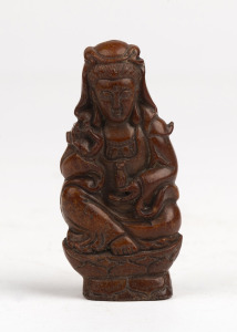 A carved stone seated Guanyin Buddhist figure, 19th century, holed on the top to be suspended as an amulet, 7cm high