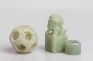 A Chinese carved jade puzzle ball, archer's ring and foo dog seal (blank), 20th century, (3 items), the largest 8cm high