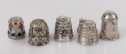 THIMBLES: A group of five silver examples, one with enamel decoration, 20th century, ​​​​​​​the largest 2cm high.