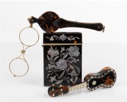 An antique tortoise shell calling card case, lorgnette and miniature guitar ornament, 19th and 20th century, (3 items), the case 10.5cm high.