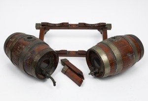 Antique pair of coopered oak port barrels with stands (damaged and with loss to tap), 19th/20th century, the barrels 20cm long