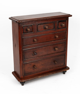 A miniature stained pine six drawer chest, 49cm high, 44cm wide, 16cm deep