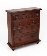 A miniature stained pine six drawer chest, 49cm high, 44cm wide, 16cm deep