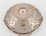 ROYAL WORCESTER antique English porcelain plaque of a flying duck by STINTON, mounted into the base of a sterling silver pierced bonbon basket, puce factory mark to base, ​​​​​​​9cm high, 11cm wide overall. - 2