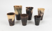 Six assorted antique horn beakers of varying sizes, including three with silver ownership plaques, 19th century, the largest 15cm high