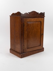 A Continental amboyna miniature one door cabinet, interior fitted with seven drawers and compartment, 19th century, 50cm high, 36cm wide, 22cm deep