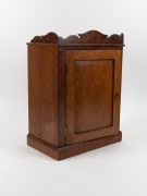 A Continental amboyna&nbsp;miniature one door cabinet, interior fitted with seven drawers and compartment, 19th century, 50cm high, 36cm wide, 22cm deep