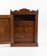 A Continental amboyna&nbsp;miniature one door cabinet, interior fitted with seven drawers and compartment, 19th century, 50cm high, 36cm wide, 22cm deep - 2