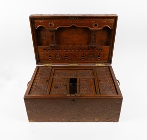 An Indian teak travelling trunk with brass inlay decoration, interior fitted with intricately carved compartments, 20th century, 25cm high, 55cm wide, 34cm deep