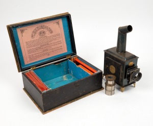THE STANDARD MAGIC LANTERN in original box with coloured slides, 19th/20th century, the case 29cm wide