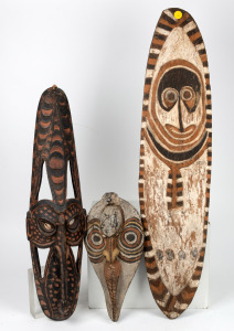 Gope board and two tribal masks, carved wood, shell and natural earth pigments, Papua New Guinea origin, 20th century, the largest 99cm long