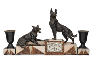 A French Art Deco three piece clock set with black slate and onyx case, adorned with spelter dogs and urn garnitures, circa 1930, 53cm high, 69cm wide