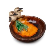 GRACE SECCOMBE&nbsp;pottery dish with applied gum leaves and a pair of kookaburras, including one with open beak, incised "Grace Seccombe", 7cm high, 13cm wide