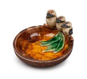 GRACE SECCOMBE pottery dish with applied gum leaves and a graduated family of three kookaburras, incised "Grace Seccombe", 7cm high, 12.5cm wide
