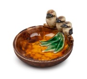 GRACE SECCOMBE pottery dish with applied gum leaves and a graduated family of three kookaburras, incised "Grace Seccombe", 7cm high, 12.5cm wide