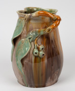 REMUED green and brown glazed pottery jug with orange highlights, adorned with branch handle, gumnuts and leaves, incised "Remued, Hand Made, 189M", 21.5cm high - 2