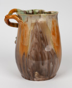 REMUED green and brown glazed pottery jug with orange highlights, adorned with branch handle, gumnuts and leaves, incised "Remued, Hand Made, 189M", 21.5cm high - 3