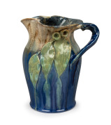 REMUED blue and green glazed pottery jug with applied gumnuts and leaves, incised "Remued, 54M", 26cm high