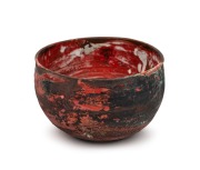 JOHN PERCEVAL burgundy glazed pottery bowl with green highlights, incised "Perceval" with date (illegible), 17cm high, 27cm wide