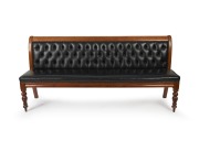 An antique Colonial Australian cedar settle upholstered in diamond button back black leather, Melbourne origin, 19th century, 98cm high, 208cm wide, 54cm deep