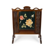 An Australian Arts & Crafts fire screen, carved blackwood with gumnuts, blossoms and wattle, circa 1900, 99cm high, 82cm wide, 41cm deep