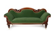 An antique Australian Colonial cedar settee with carved decoration and green velvet upholstery, mid 19th century, 98cm high, 224cm wide, 65cm deep