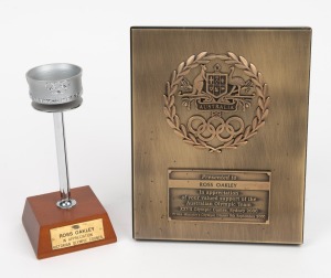 1956 Olympic Torch replica on wooden presentation stand, height 16.5cm, with plaque that reads 'TO ROSS OAKLEY - IN APPRECIATION VICTORIAN OLYMPIC COUNCIL'. Accompanied by a 16 x 20cm bronze plaque featuring the Australian coat of arms and Olympic symbols, with engraving that reads 'Presented to ROSS OAKLEY in appreciation of your valued support of the Australian Olympic Team, XXVII Olympic Games Sydney 2000, Prime Minister's Olympic Dinner 9th September 2000'. (2 items)