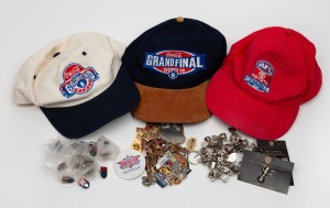 Group lot of AFL branded items from various seasons, comprising three caps, twenty-four premiership cup pins, twenty-eight grand final pins/badges/keyrings, and nineteen AFL/Coca Cola pins. (74 items)